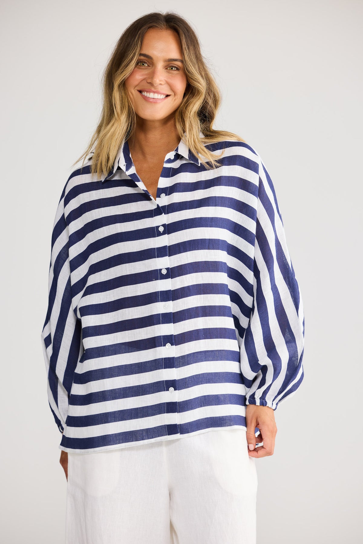 Cliffside Shirt in Navy Stripe with exaggerated grown on sleeve and elasticated cuffs.