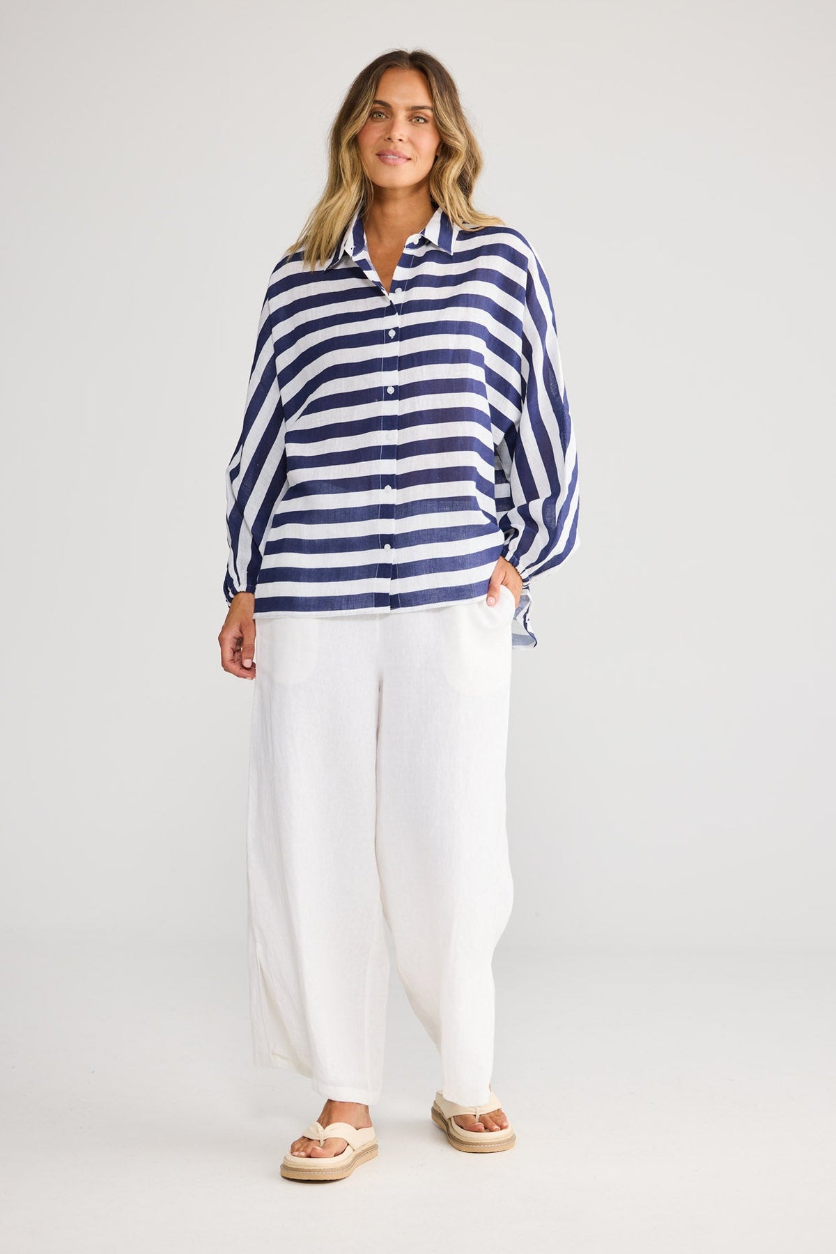 Model wearing Cliffside Shirt in navy stripe, front view. Oversized, button front, balloon sleeve.