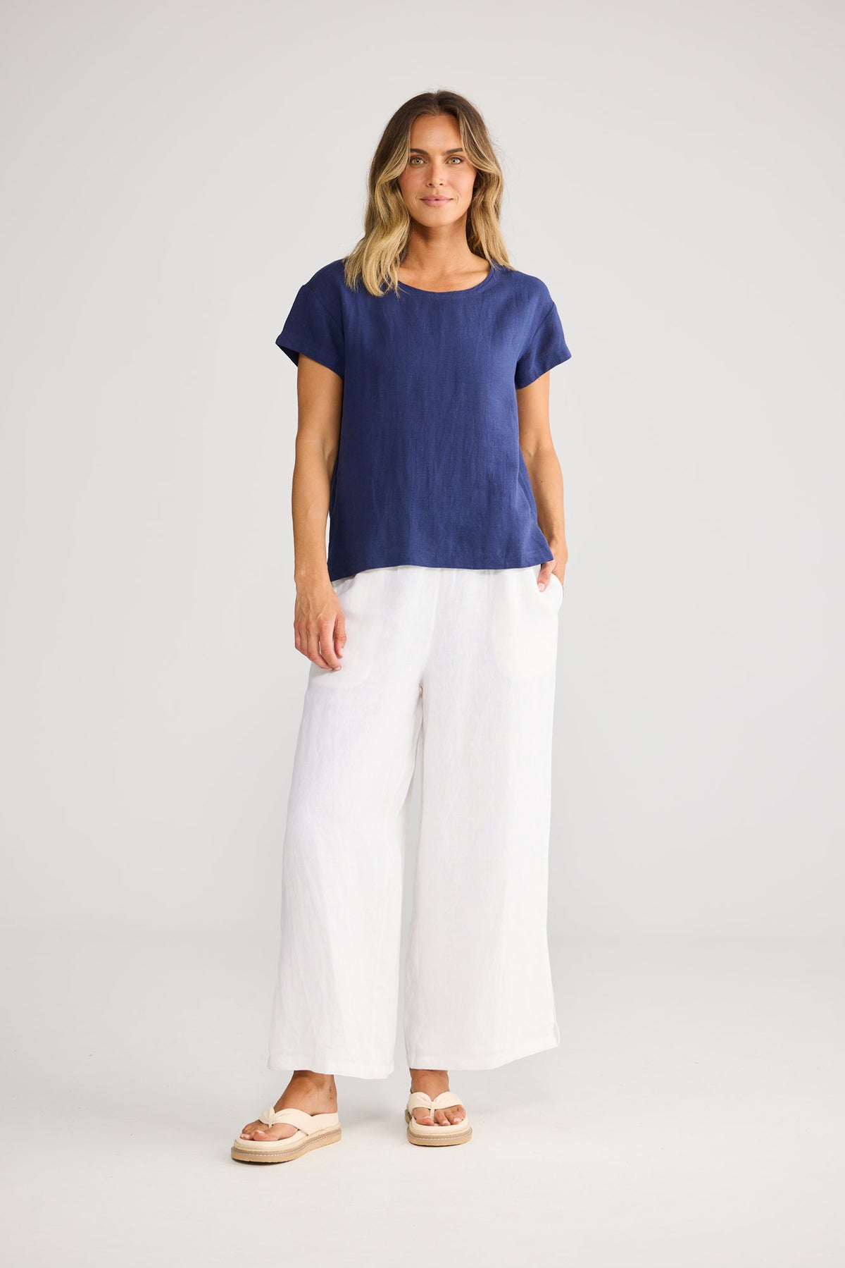 Model wearing Captain Tee in navy, front view. Round neckline, short sleeves, classic fit.