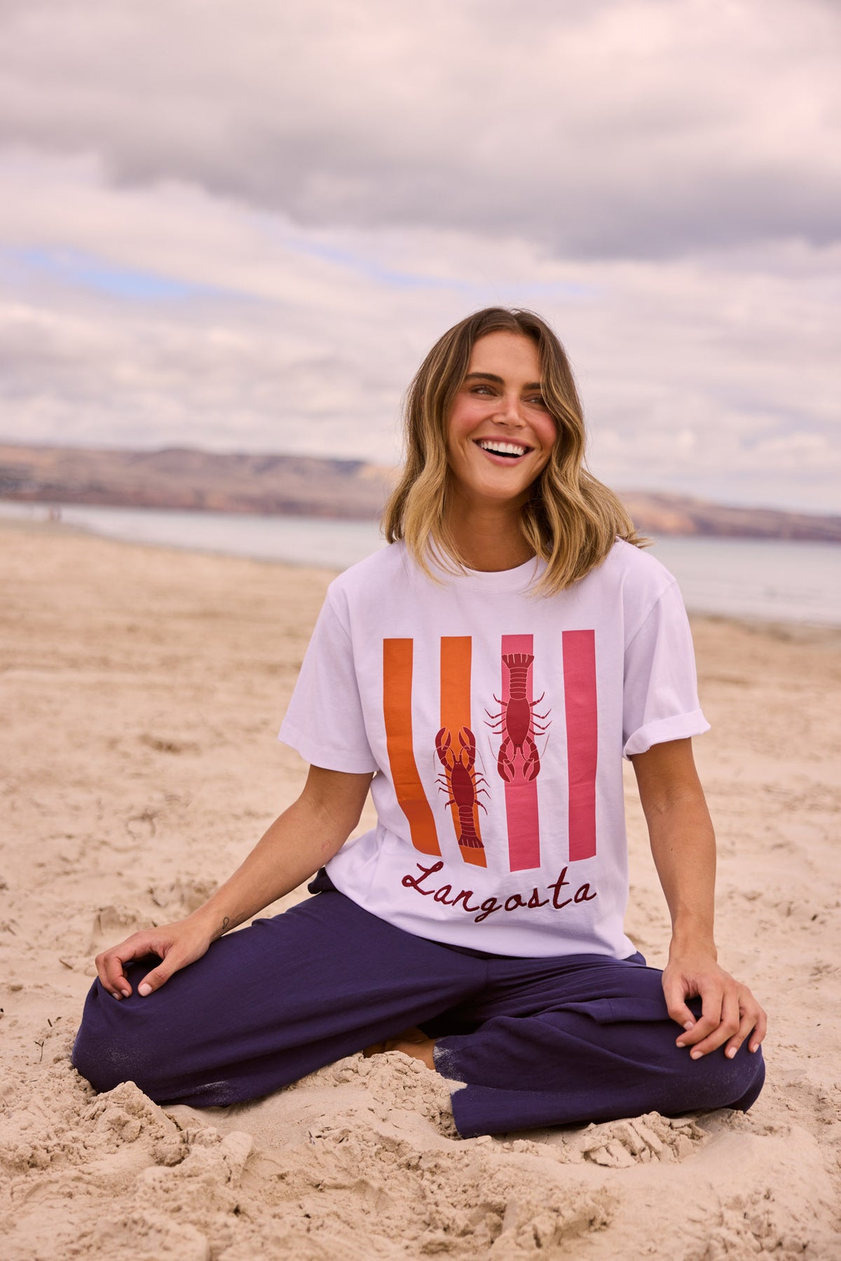 Model wearing Cove Tee in white, front view. Round neck, short sleeve, mermaid graphic motif at chest.
