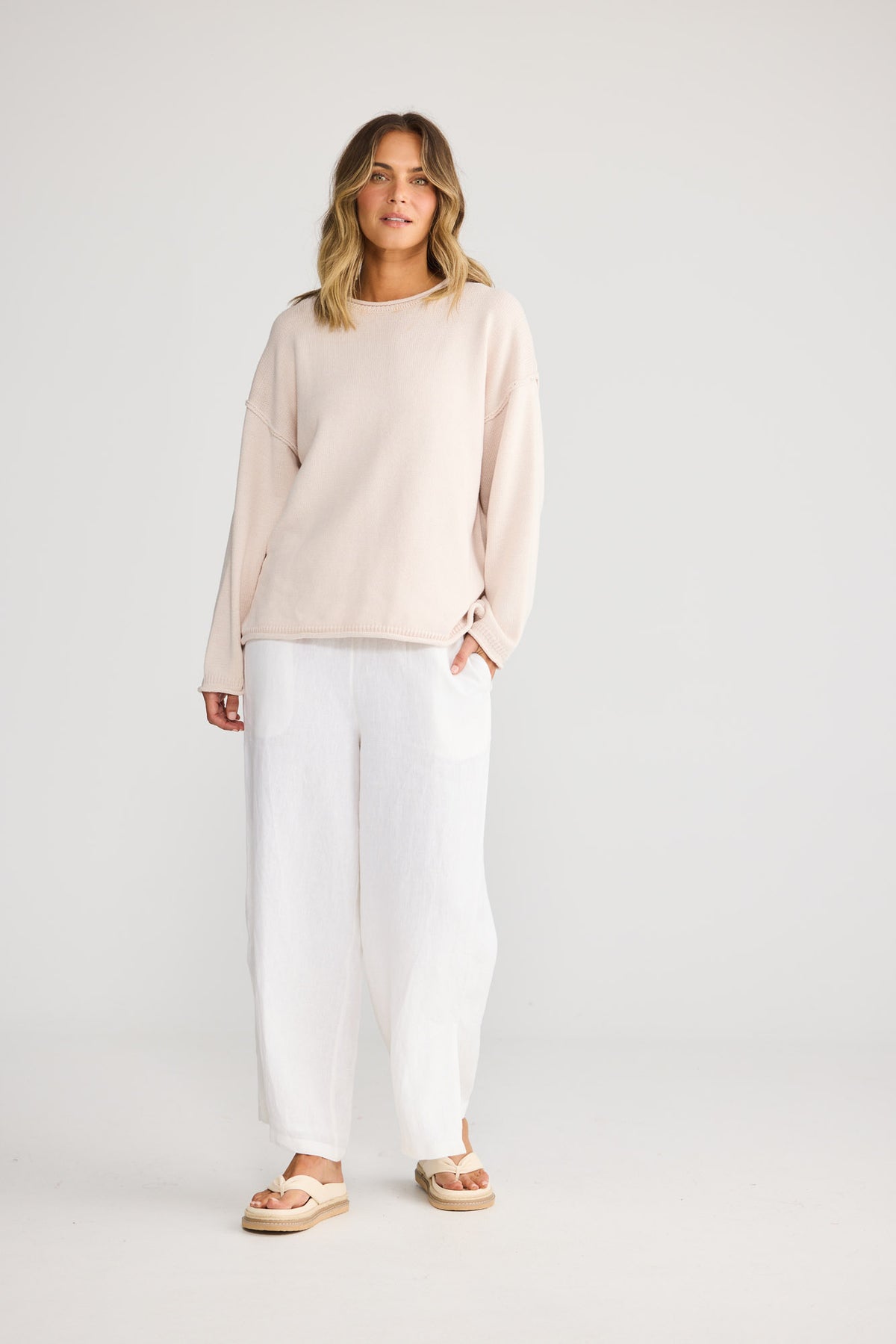 Model wearing Breaker Knit in dove, front view. Relaxed crew neck knit with rolled cuffs.