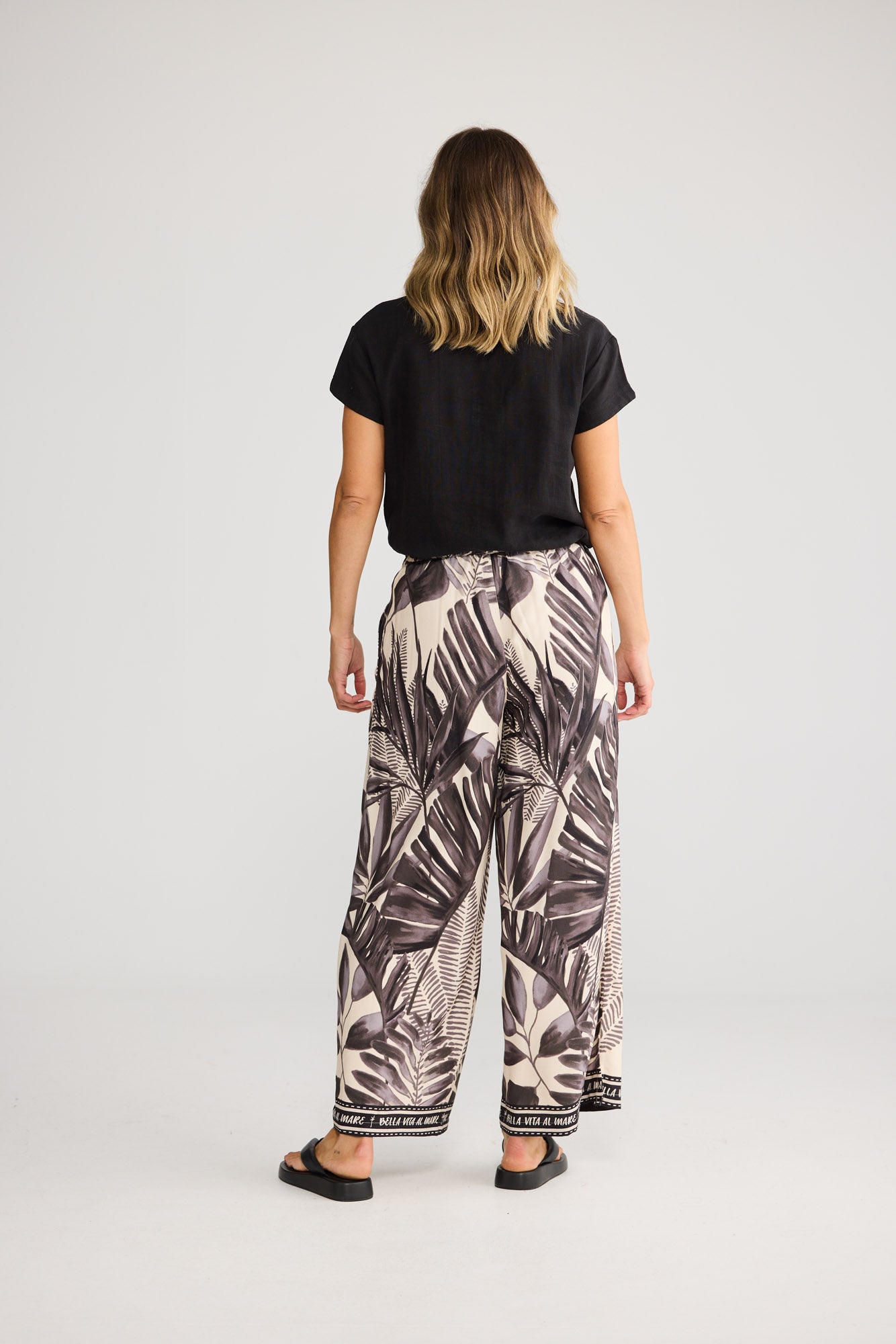 Fly Away Pant in Sunset Palm with full length.