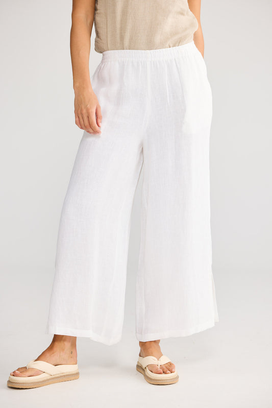 Model wearing Fly Away Pant in white, front view. Relaxed wide leg, elasticated waistband.