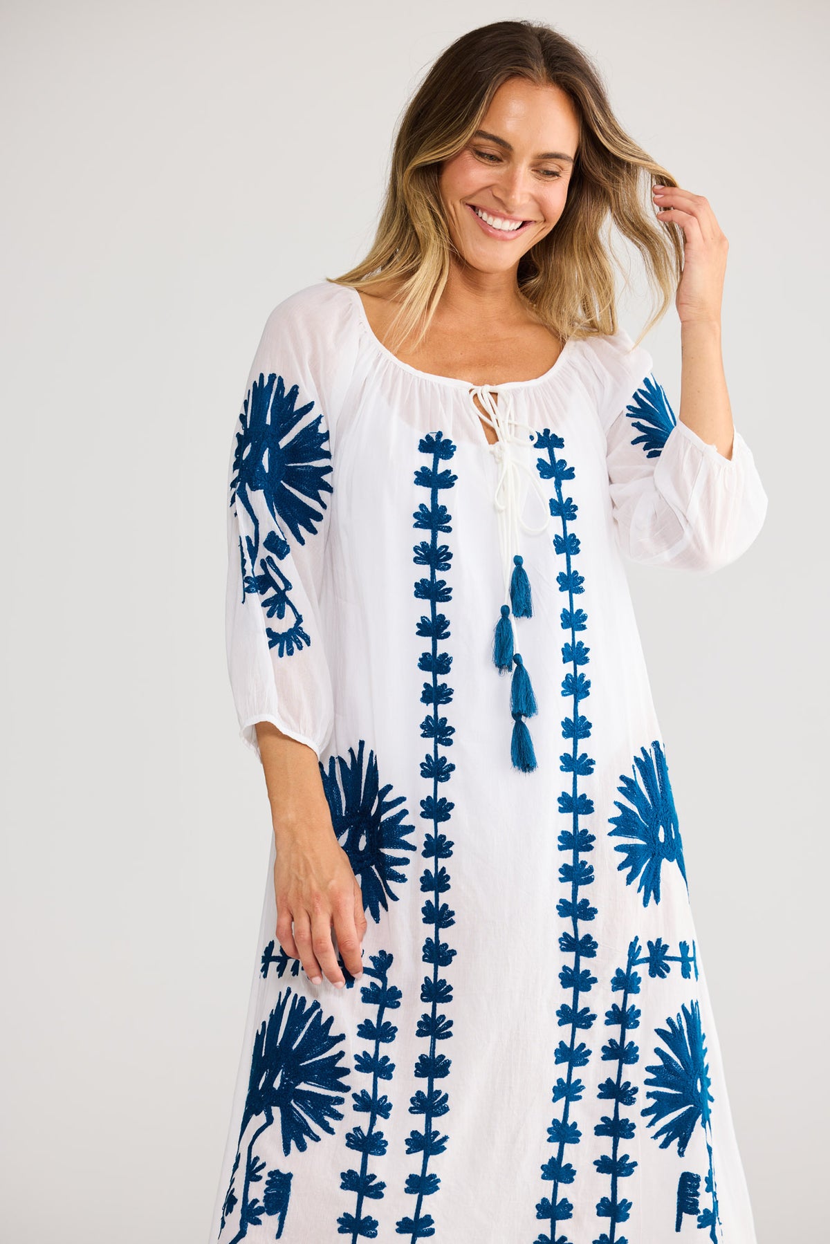 Aloha Dress in White with round neckline with front tie opening.