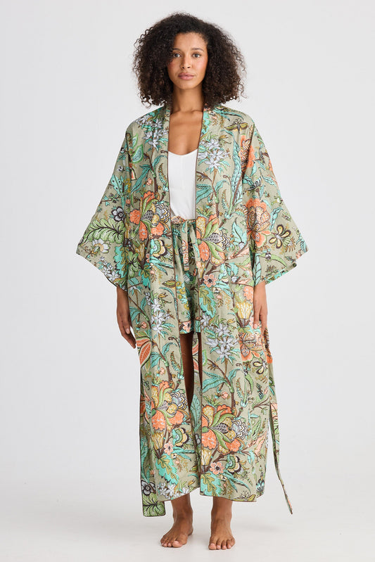 Woman wearing a floral kimono-style robe on a white background