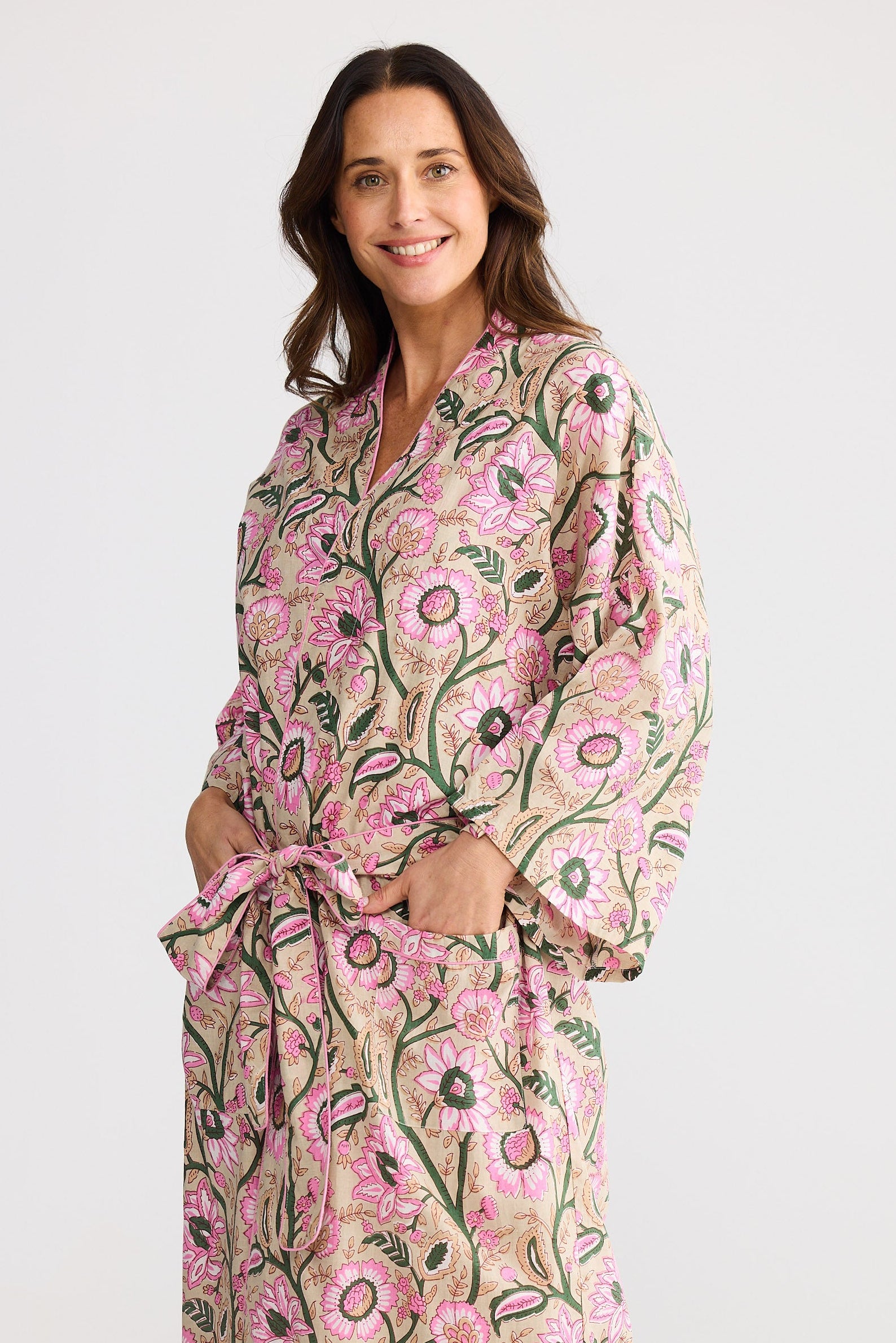 Woman wearing a floral patterned robe on a white background