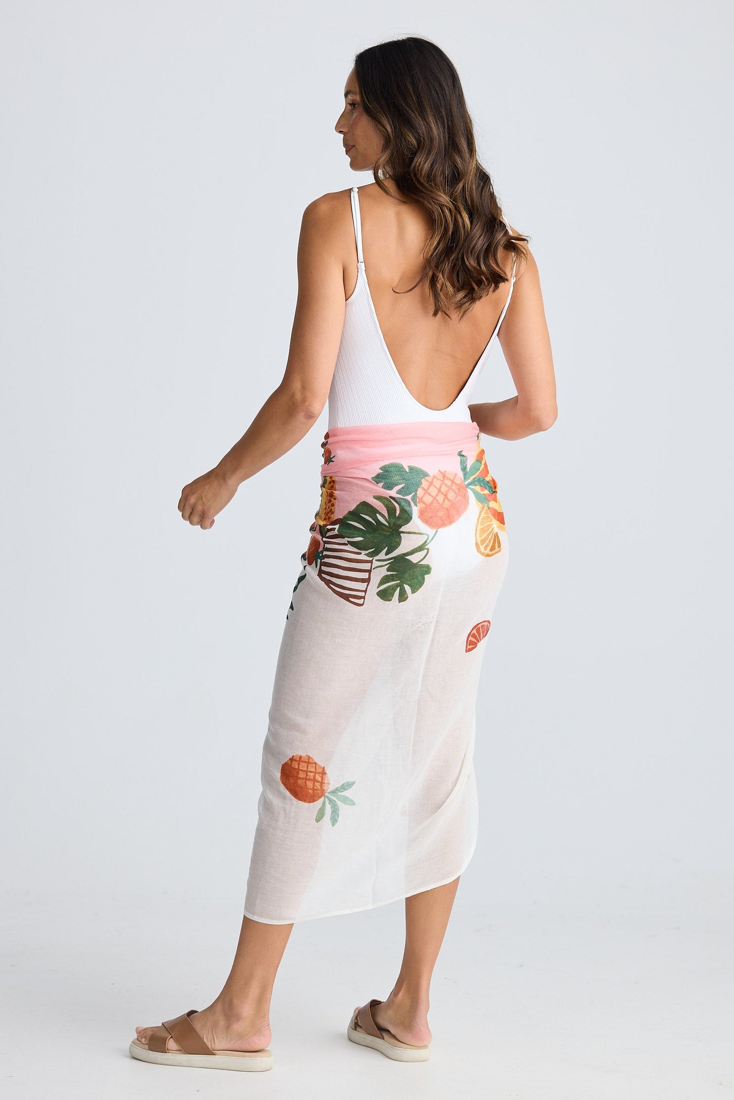 Woman wearing a floral sarong on a white background