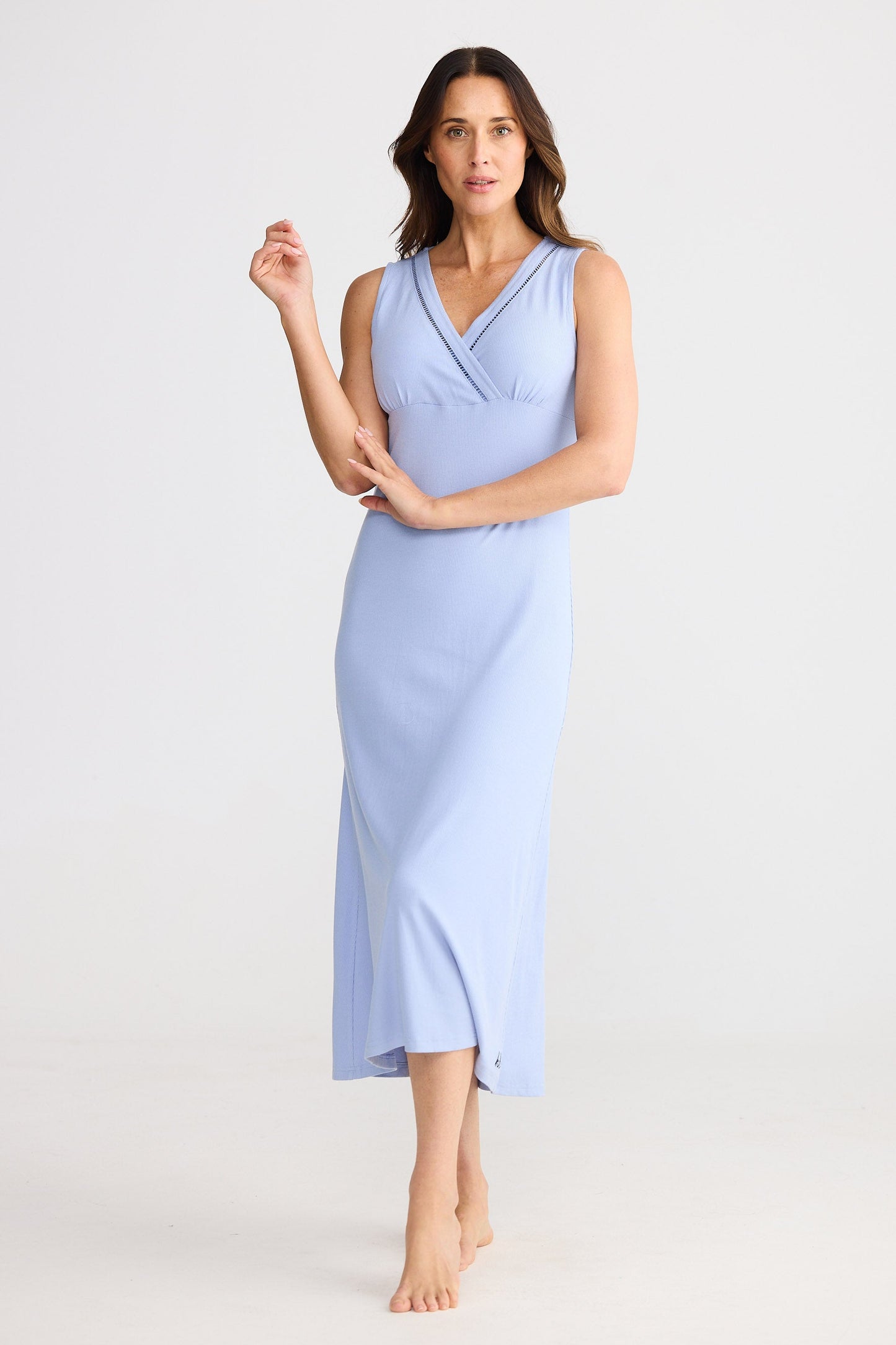 Woman wearing a light blue dress against a white background