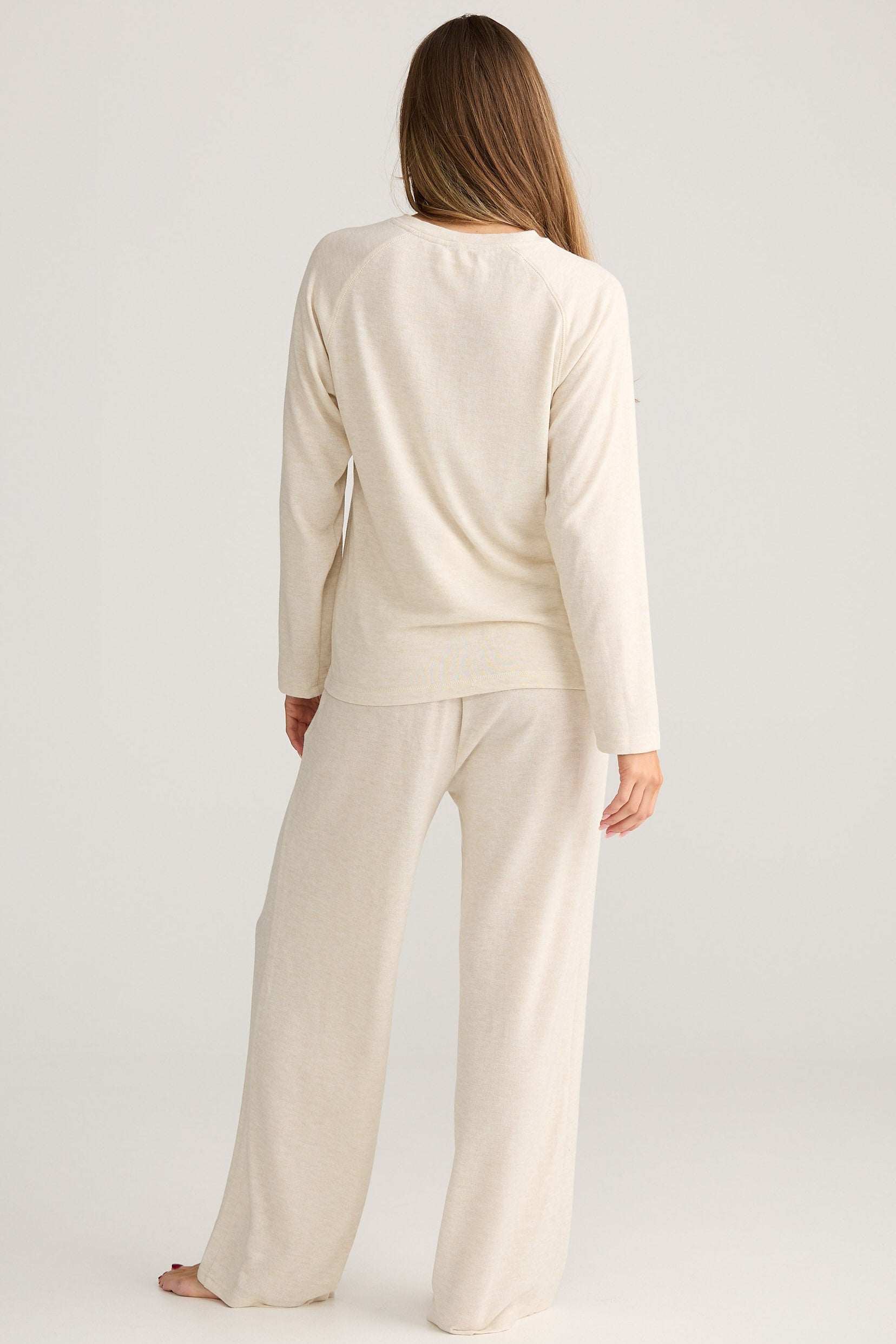 Woman wearing a beige outfit on a white background