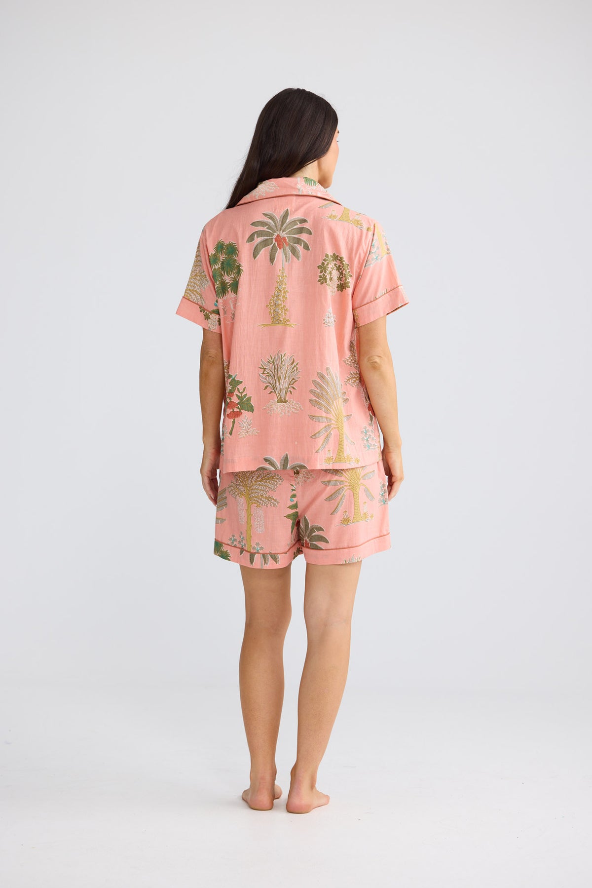 Namaste Pyjama Set in Baby Pink Palm with a button-through shirt.