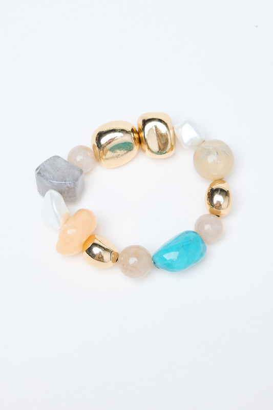 Multicolored beaded bracelet with gold clasp on a white background