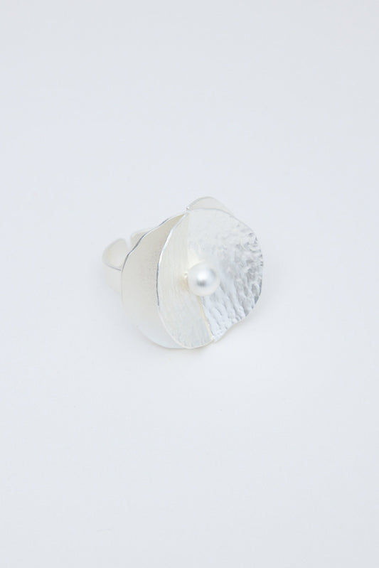 Silver ring on a light gray background