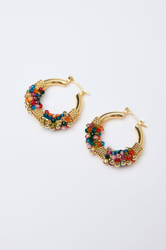 Gold hoop earrings with colorful beads on a white background