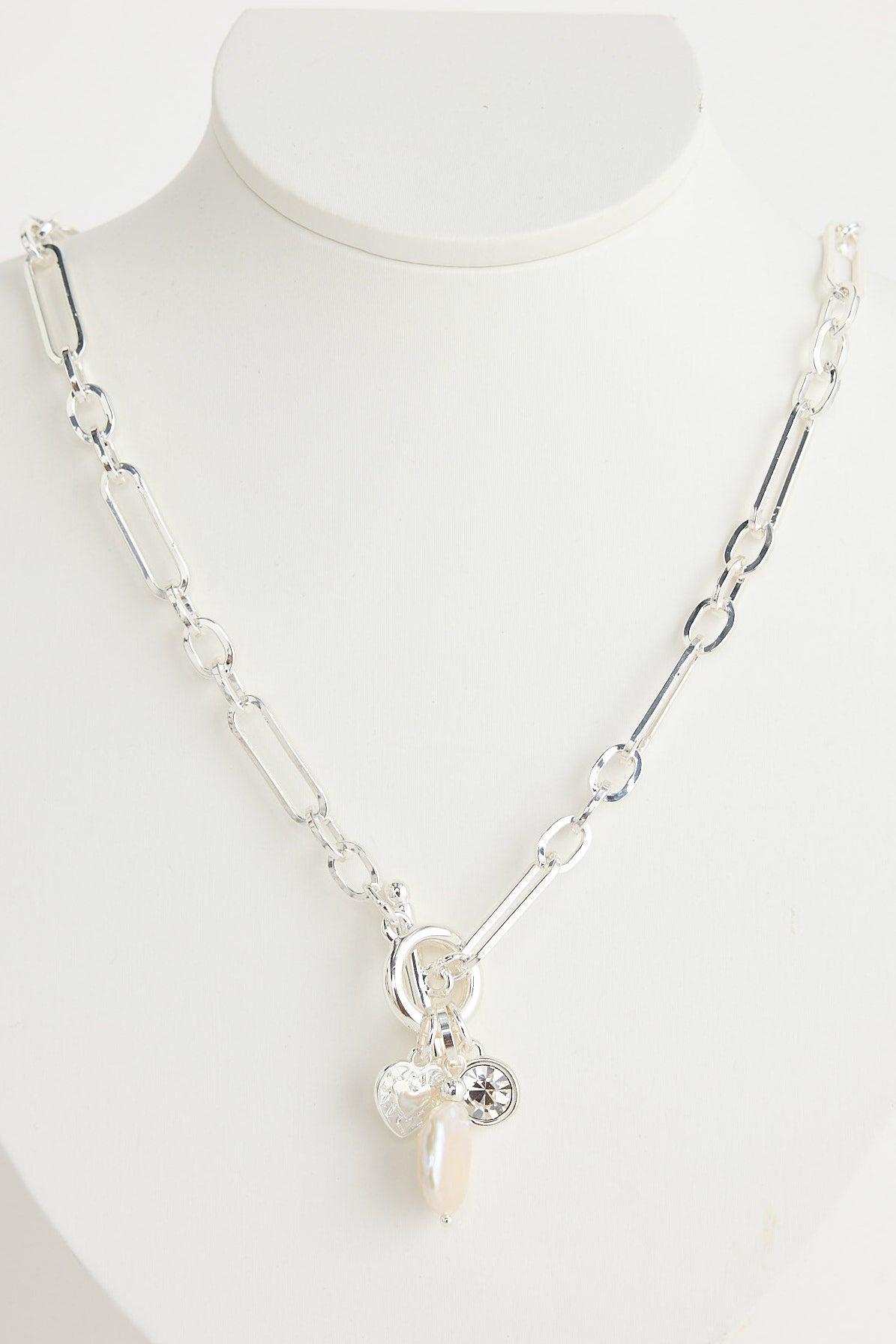 Silver necklace with a pendant on a white mannequin