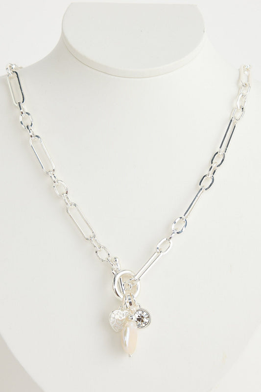 Silver necklace with a pendant on a white mannequin