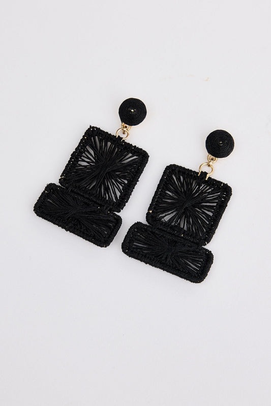 Black textured earrings on a white background