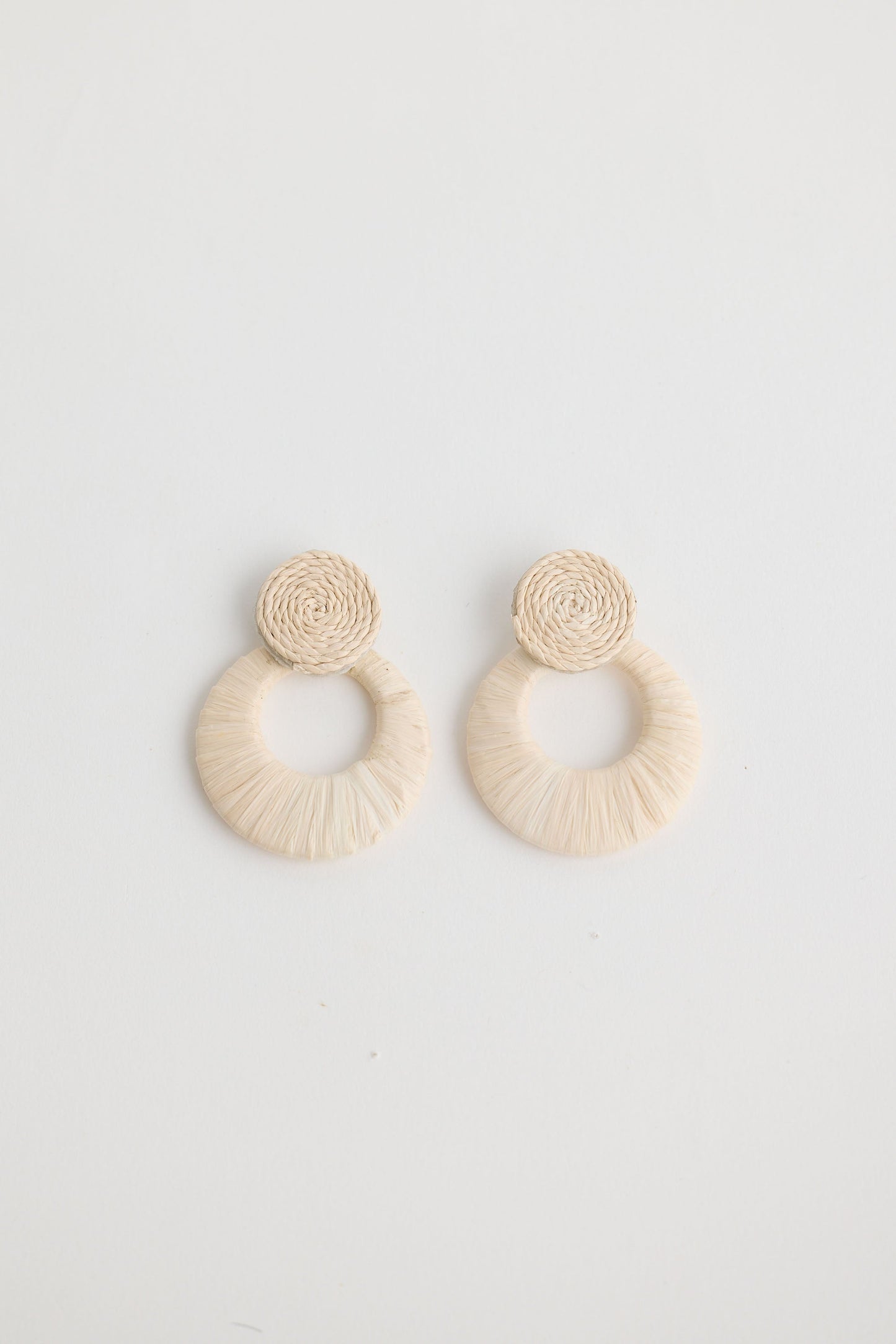 Close-up of natural eloise earrings earrings on white background.