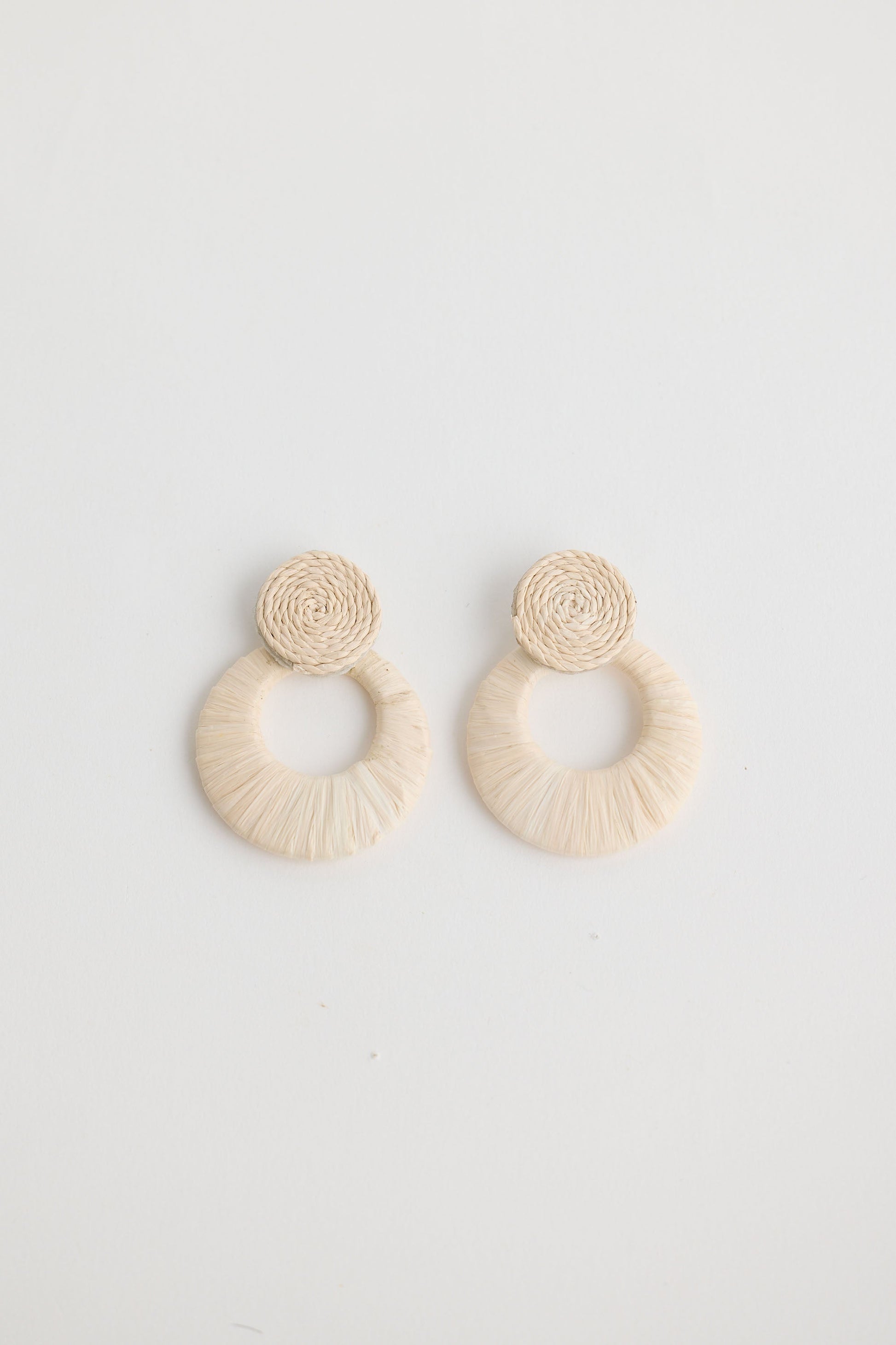 Close-up of natural eloise earrings earrings on white background.