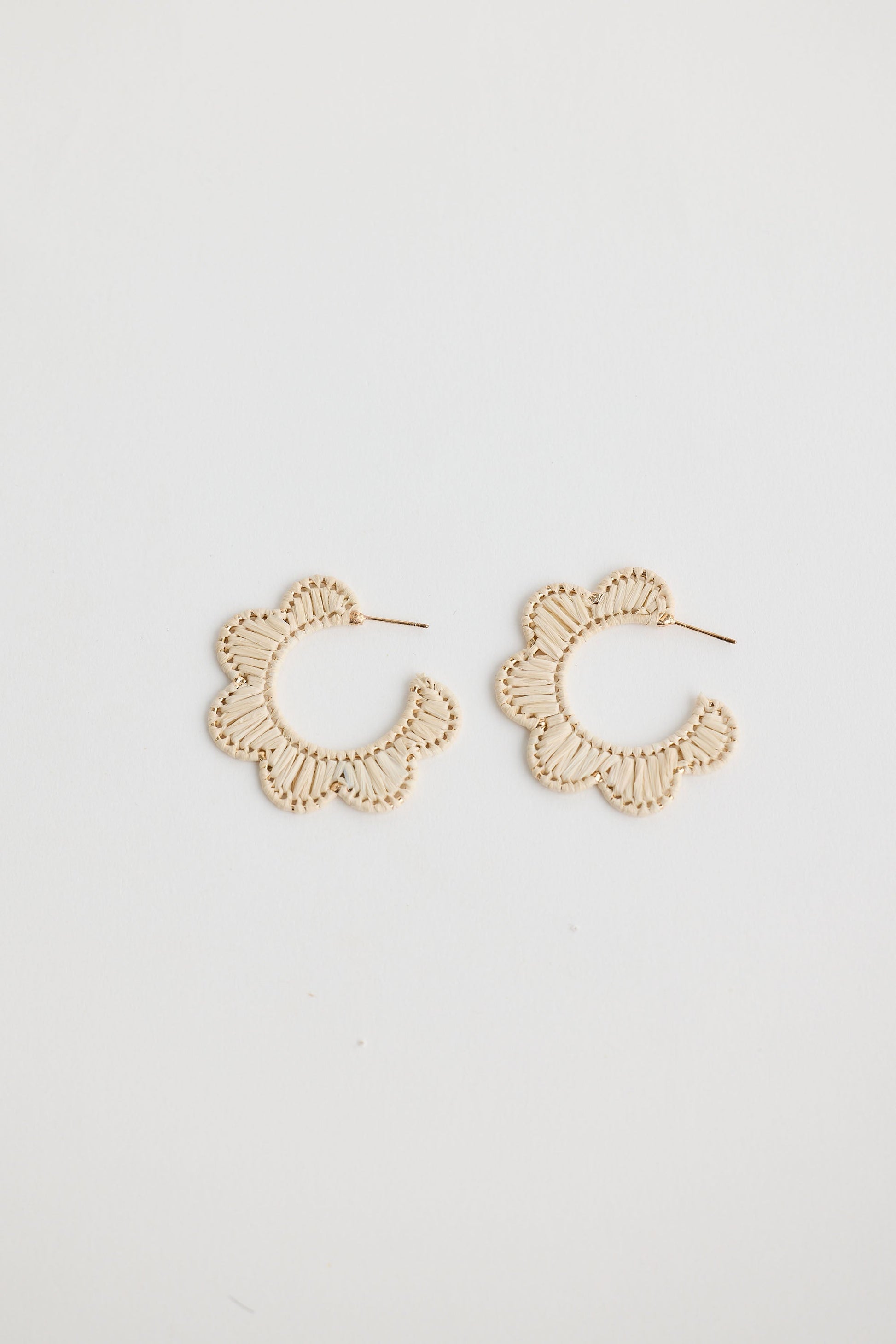 Close-up of natural hannah earrings earrings on white background.