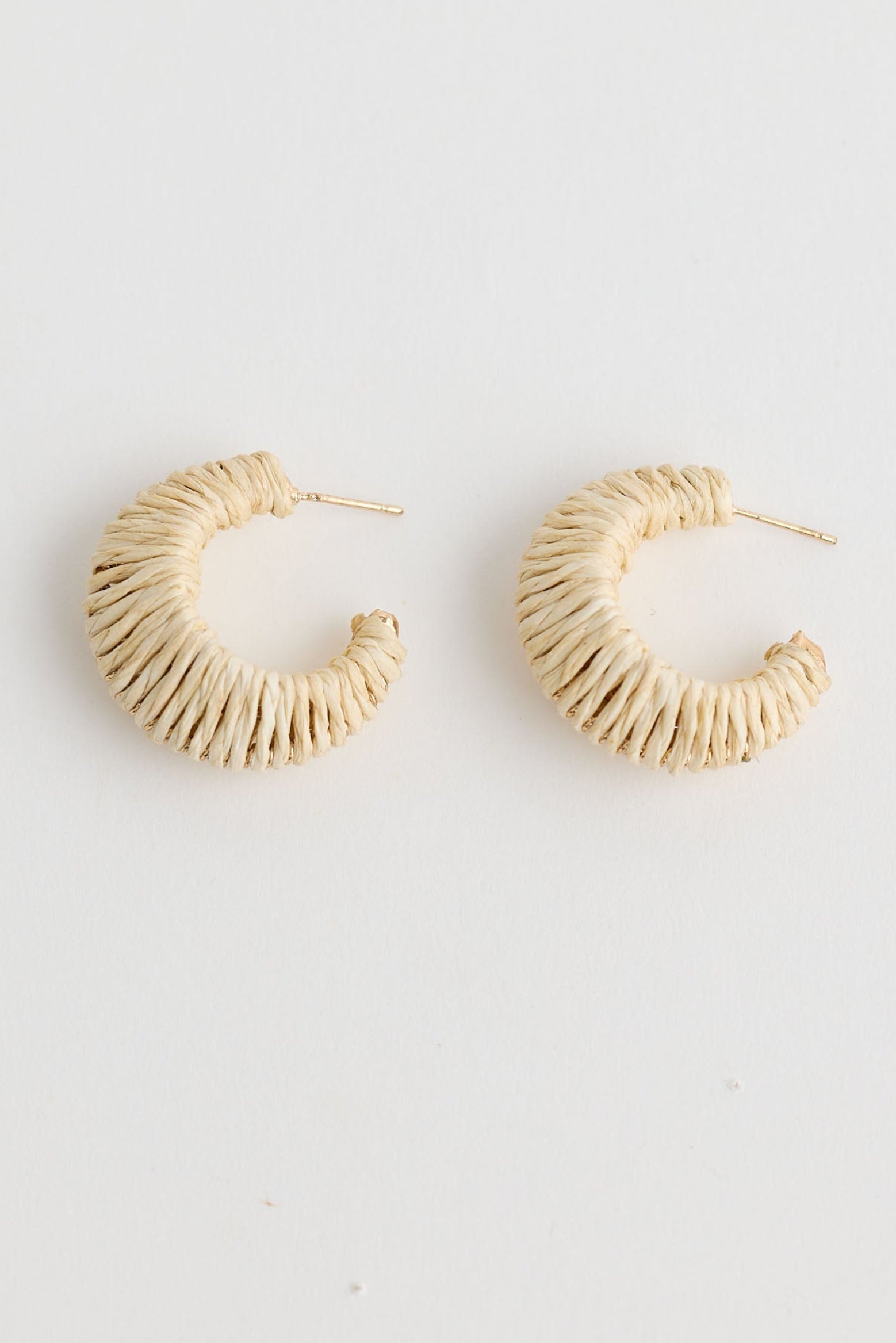 Close-up of natural nala earrings earrings on white background.