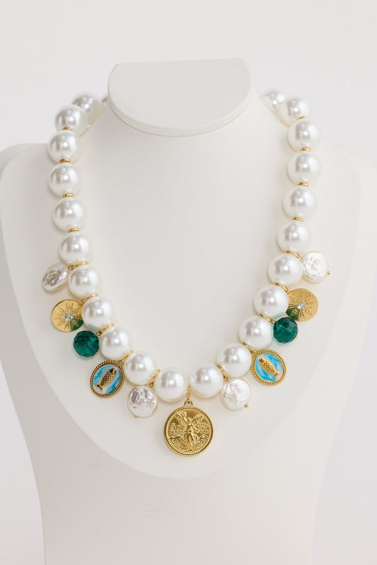 Necklace with pearls and colorful pendants on a mannequin bust against a white background