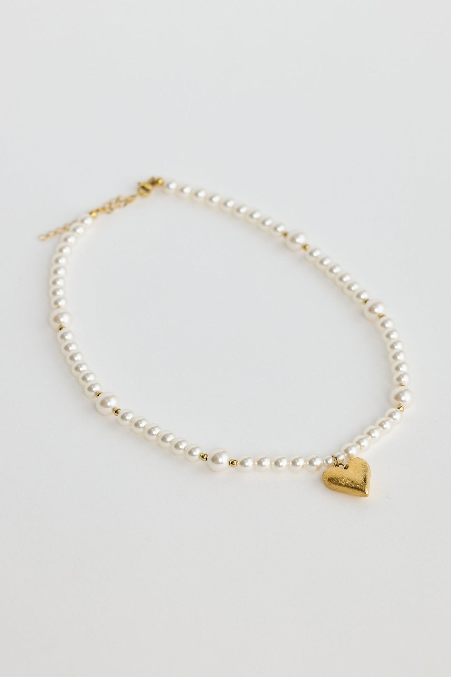 Close-up of pearl mia necklace necklace on white background.