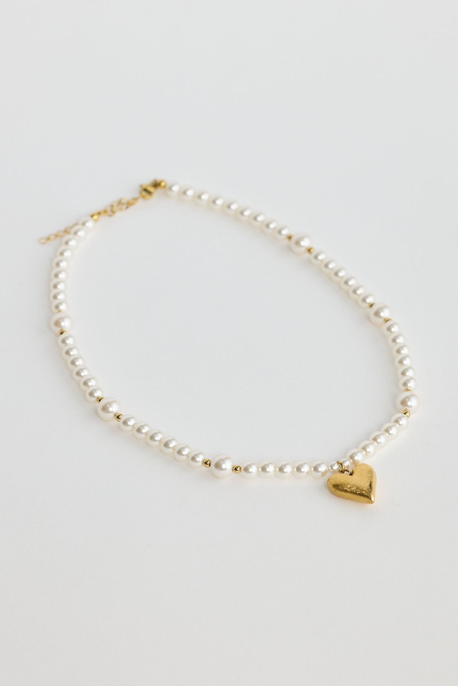 Close-up of pearl mia necklace necklace on white background.