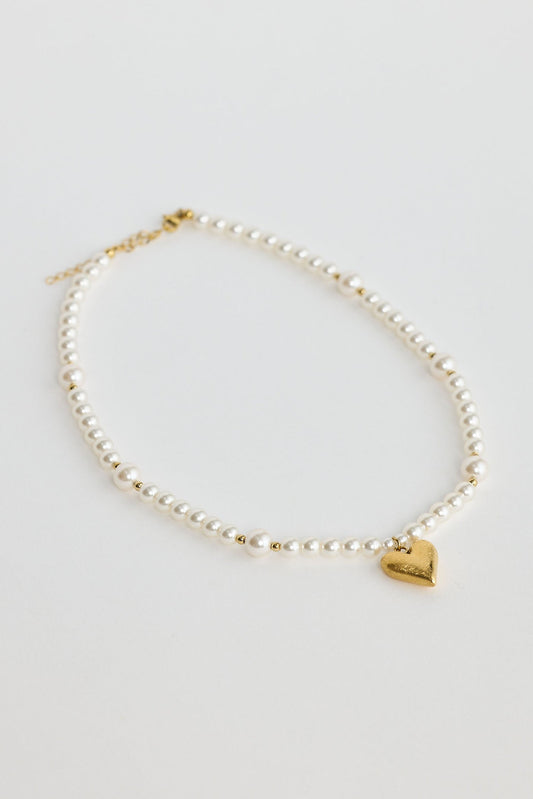 Close-up of pearl mia necklace necklace on white background.