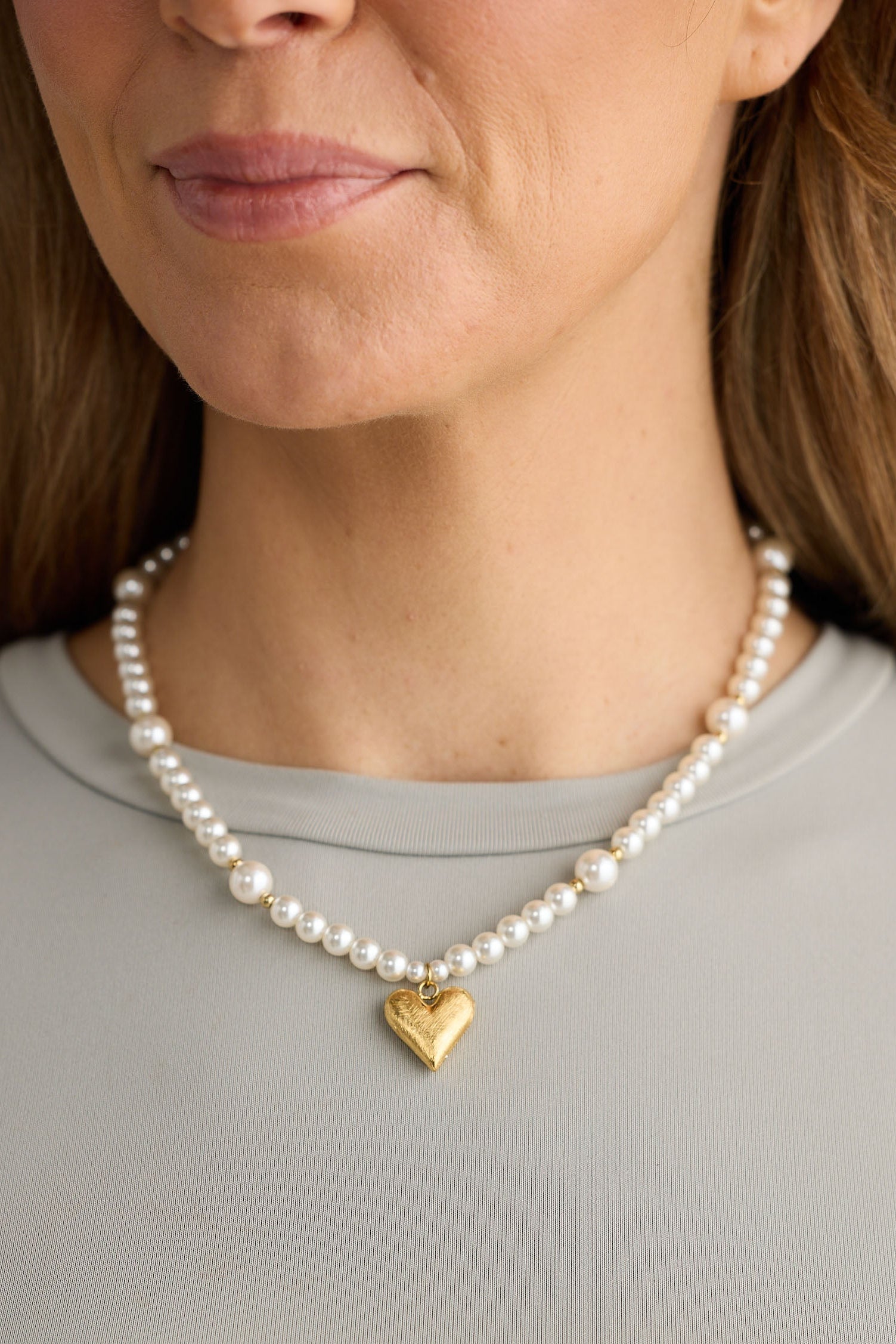 Close-up of pearl mia necklace necklace on white background.