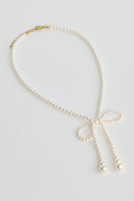 Close-up of pearl ella necklace necklace on white background.