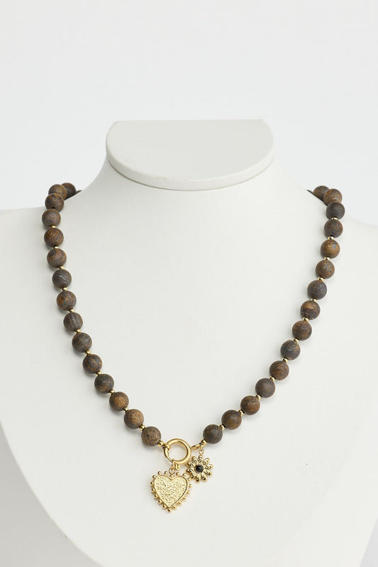 Close-up of black kindness necklace necklace on white background.