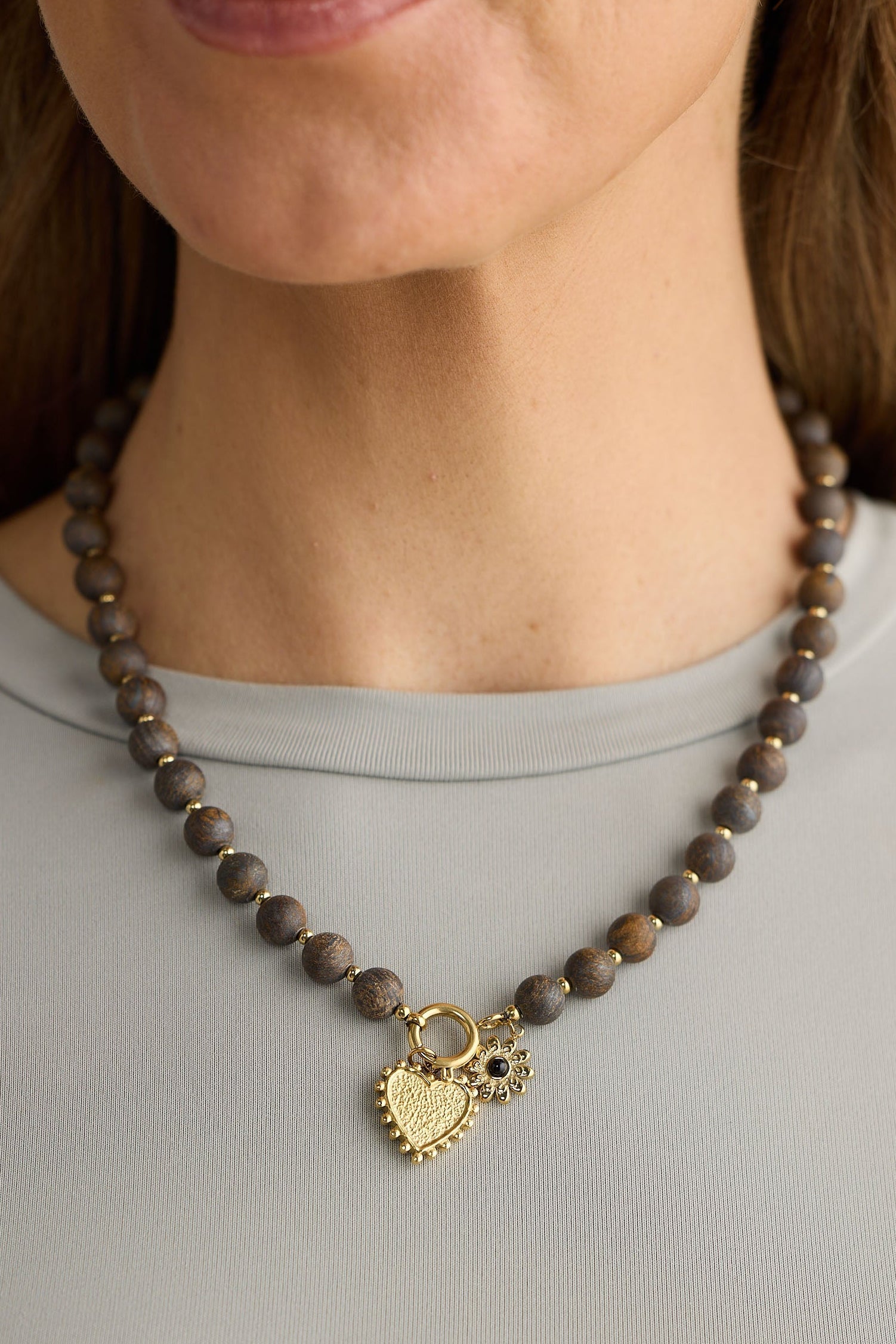 Close-up of black kindness necklace necklace on white background.