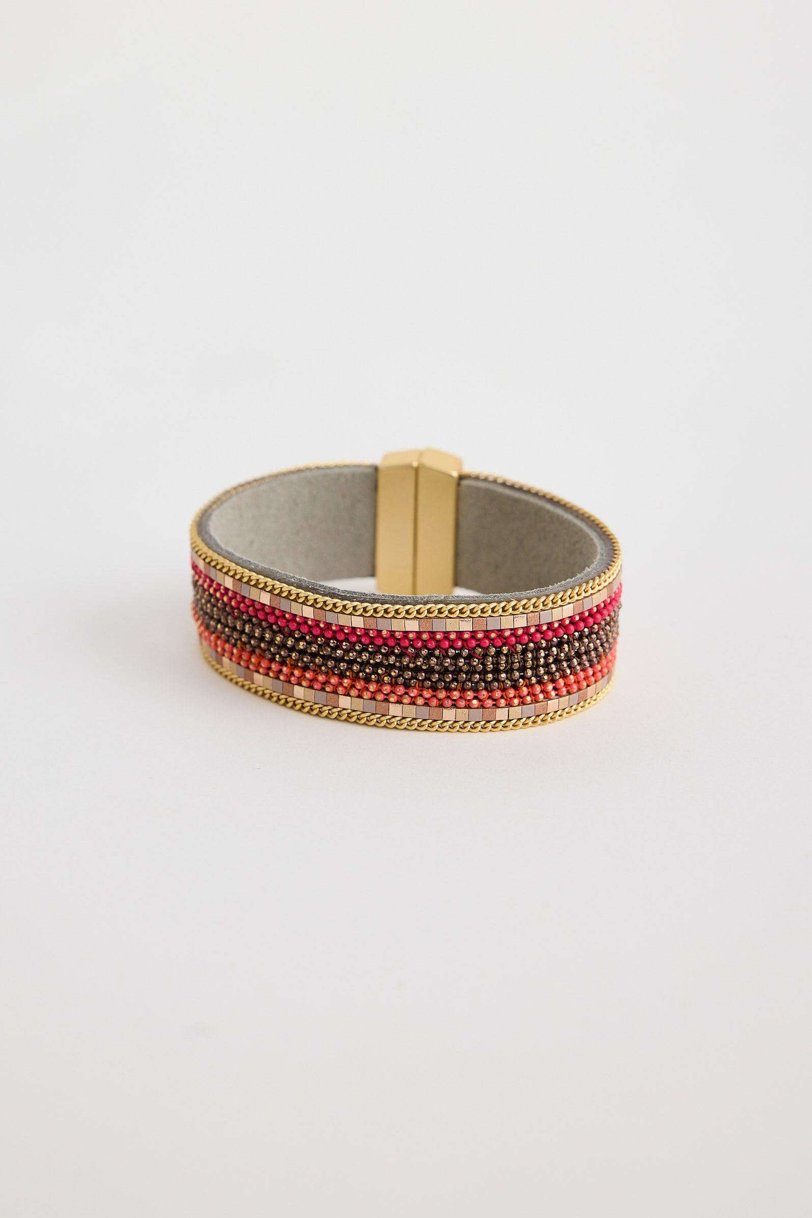 Beaded bracelet with red and gold accents on a light gray background