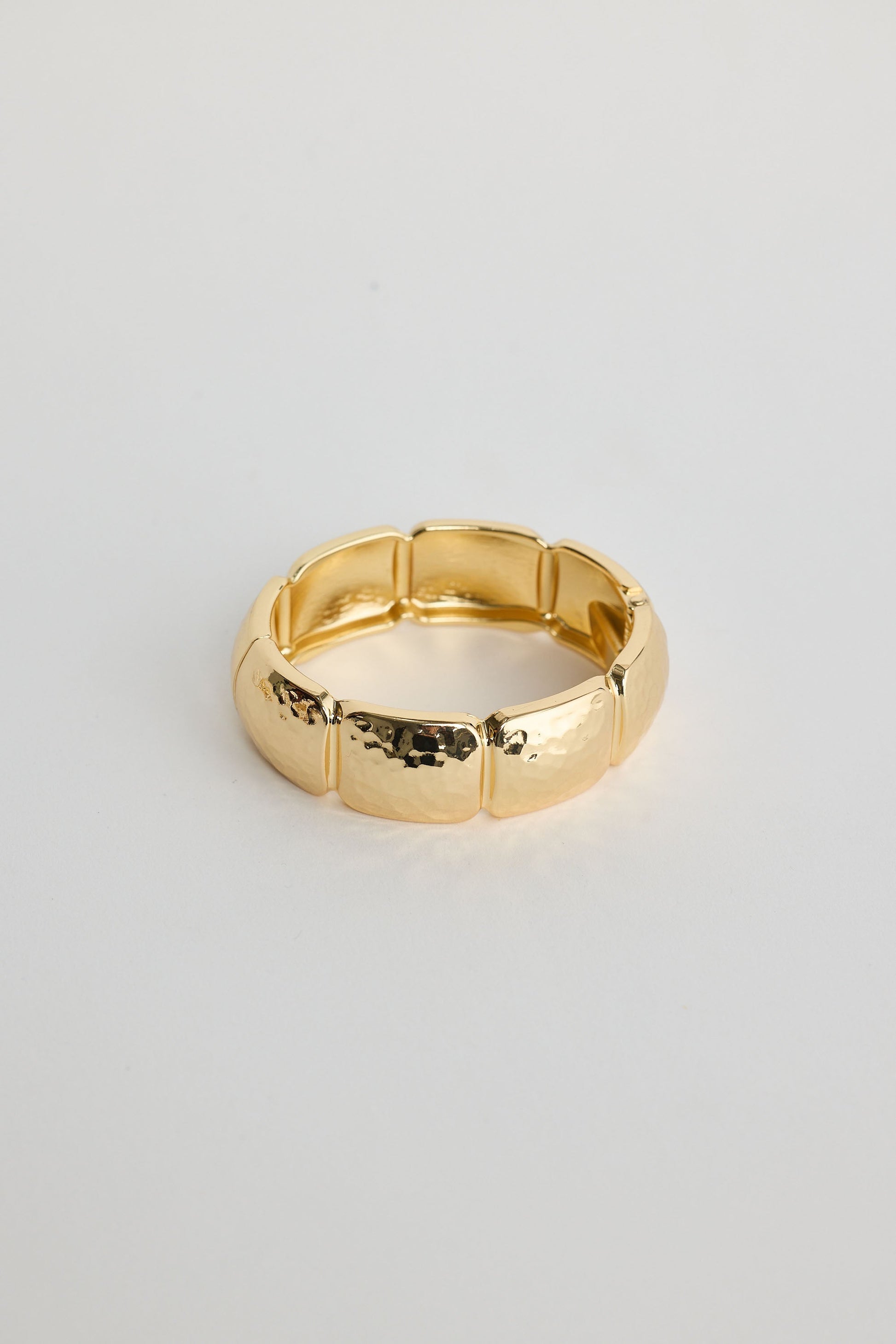 Close-up of gold monterey bracelet bracelet on white background.