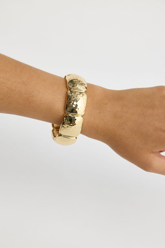 Close-up of gold monterey bracelet bracelet on white background.