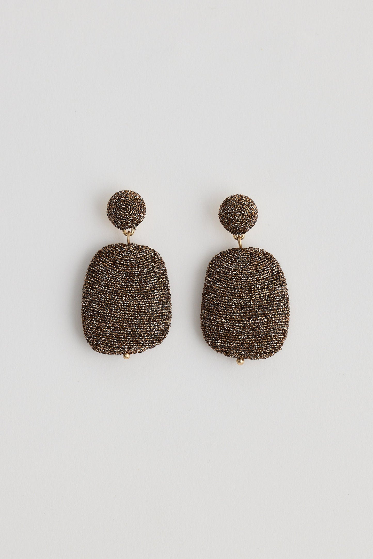 Pair of textured earrings on a white background