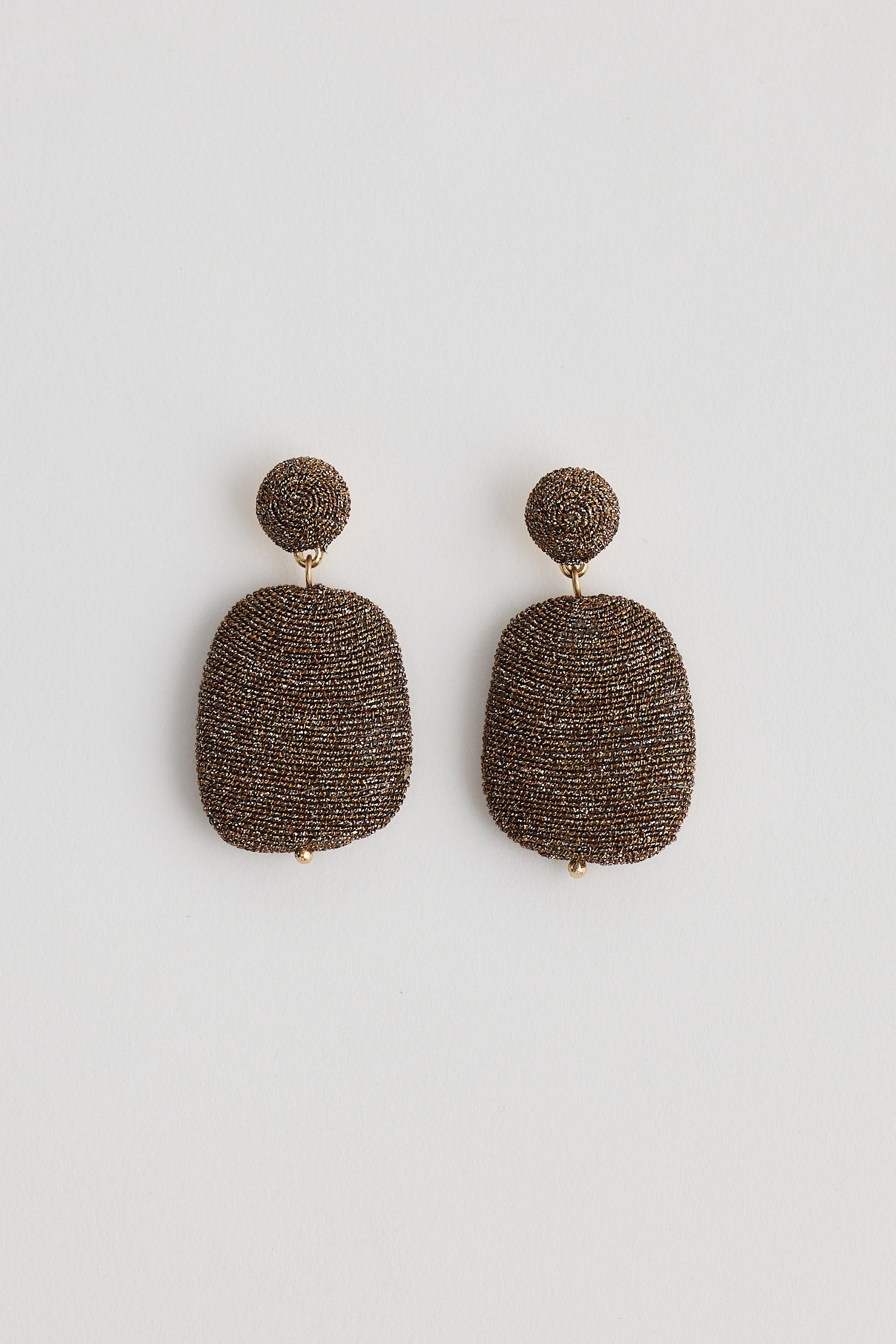Pair of textured earrings on a white background