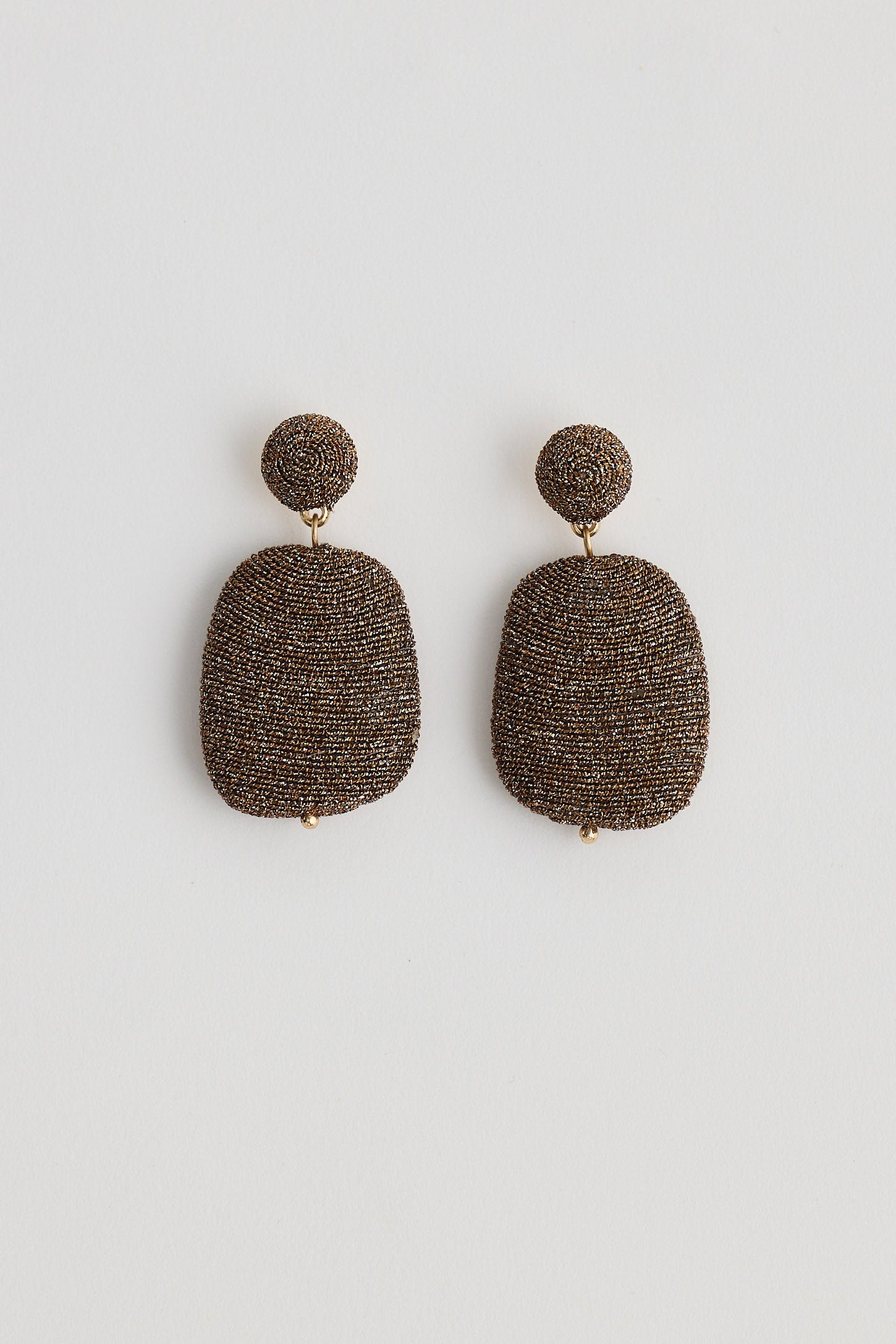 Pair of textured earrings on a white background