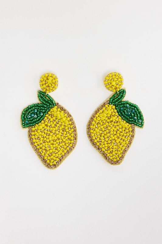 Pair of large beaded lemon drop earrings in bright yellow seed beads with a gold crystal border and green beaded leaf detail, with a round yellow beaded stud, laid flat on a white background