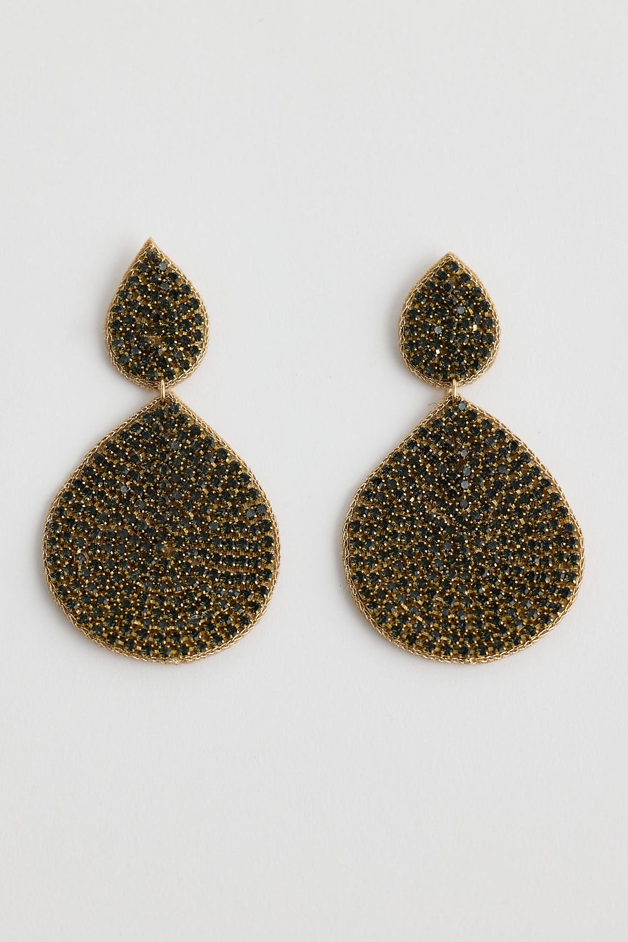 Pair of gold teardrop earrings on a white background