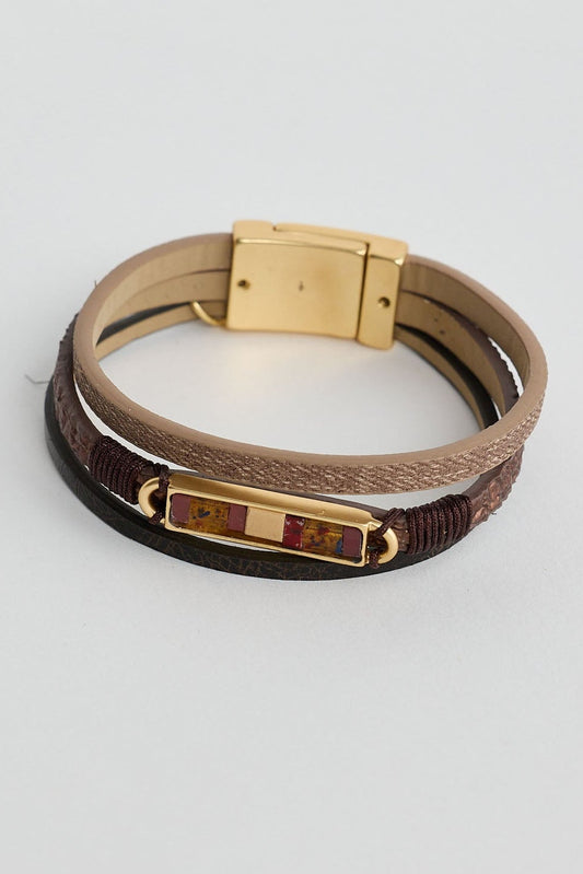 Multistrand bracelet with gold clasp on a light gray background