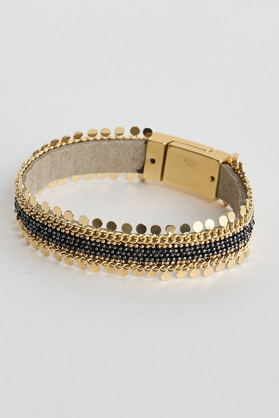 Gold bracelet with black on a light gray background