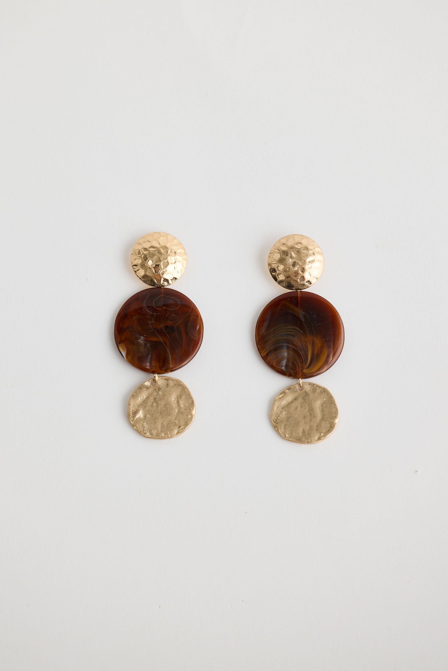 Close-up of amber amara earrings earrings on white background.