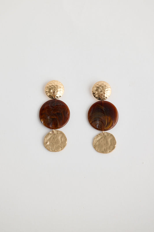 Close-up of amber amara earrings earrings on white background.