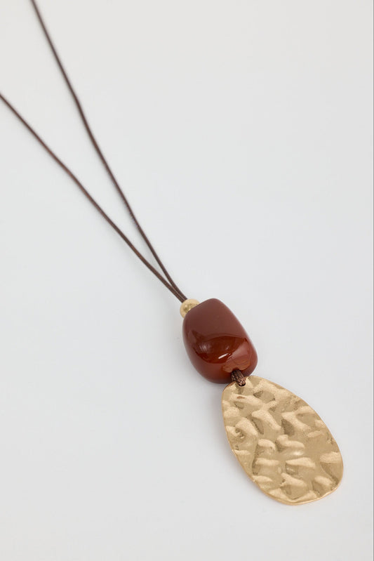Close-up of chestnut westwing necklace necklace on white background.