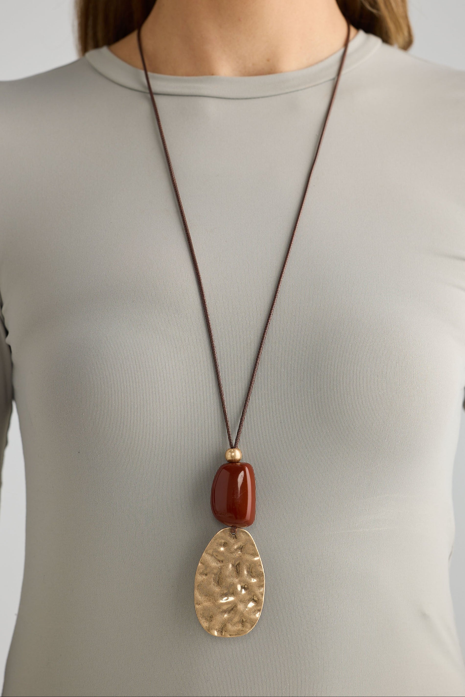 Close-up of chestnut westwing necklace necklace on white background.