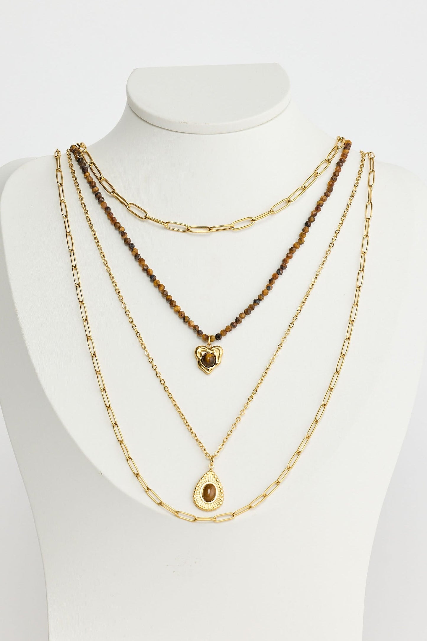 Close-up of gold alex necklace necklace on white background.