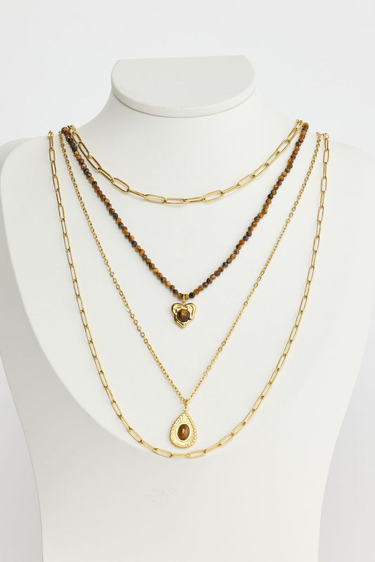 Close-up of gold alex necklace necklace on white background.