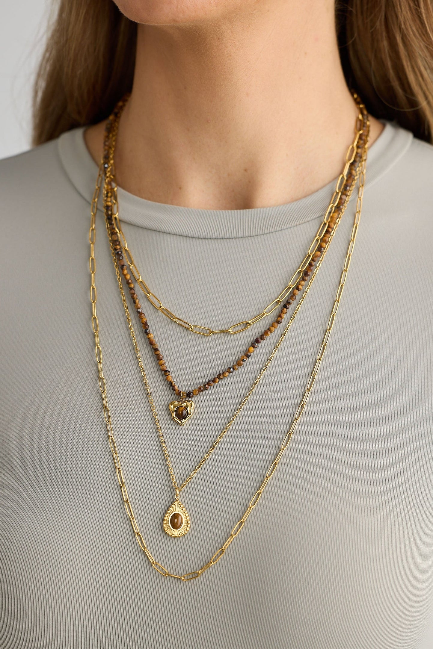 Close-up of gold alex necklace necklace on white background.