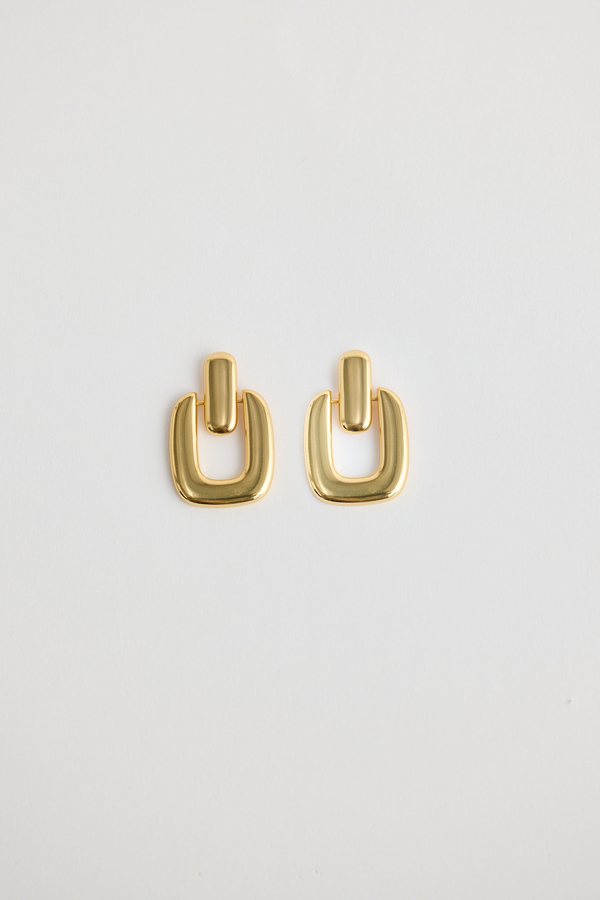 Close-up of gold avery earrings earrings on white background.
